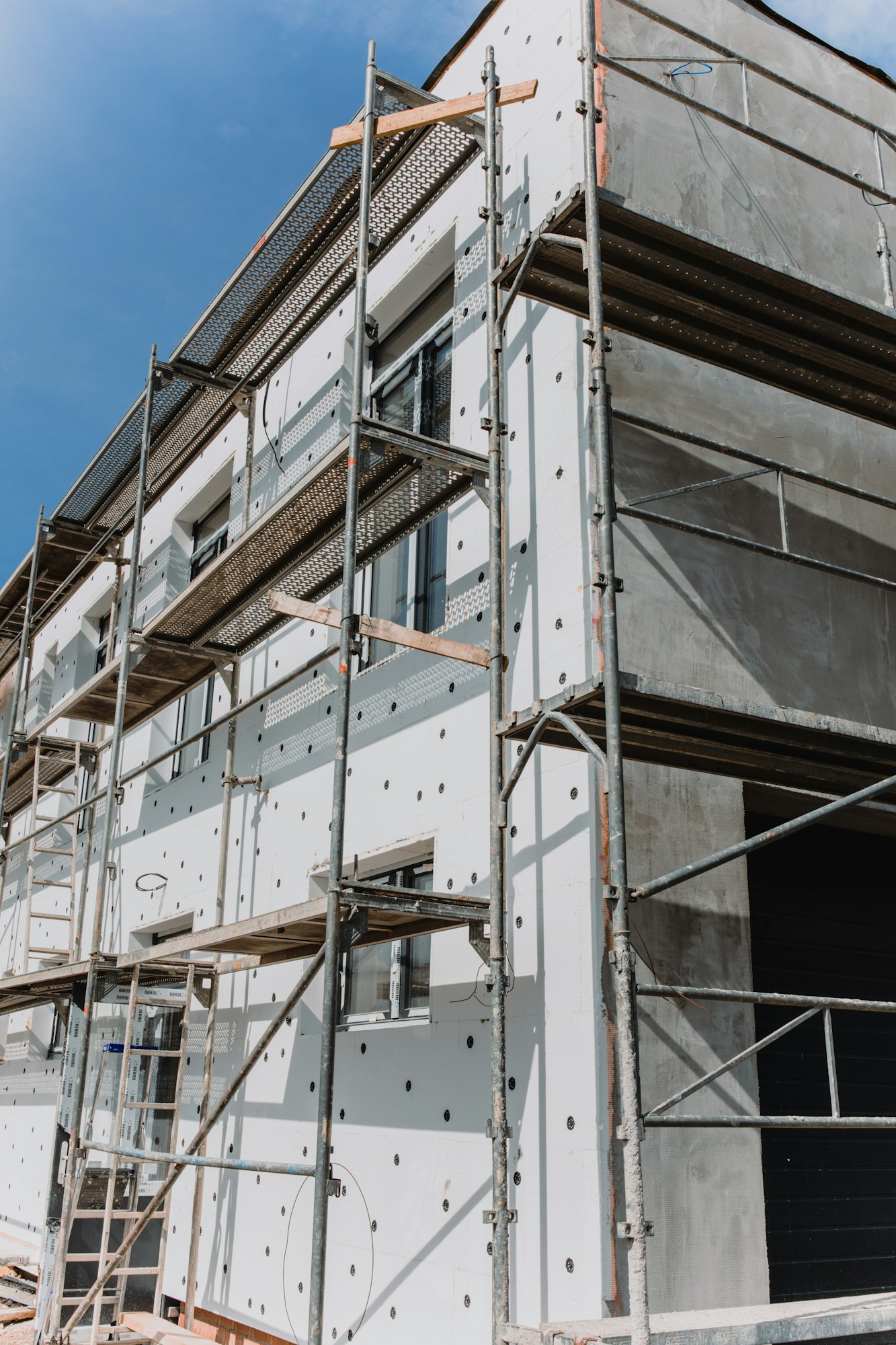 scaffolding on house facade,modern building under construction -